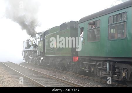 Sir Archibald Sinclair a rebuilt Battle of Britain class locomotive pulling a passenger train out of Sheffield Park station. Stock Photo