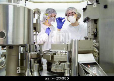 Encapcsulation Machine Operators Working Performing technical controls during an encapsulation process ...