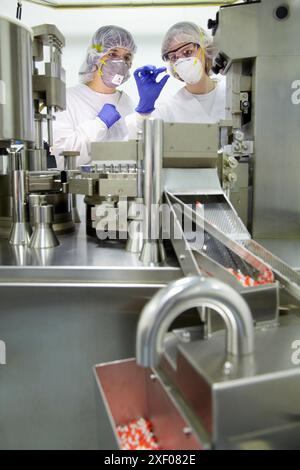 Encapcsulation Machine Operators Working Performing technical controls during an encapsulation process ...