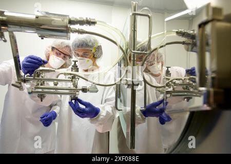 Technicians performing maintenance functions on a solid coating machine, Clean room, Pharmaceutical plant, Drug manufacturing plant, Research Center, Stock Photo