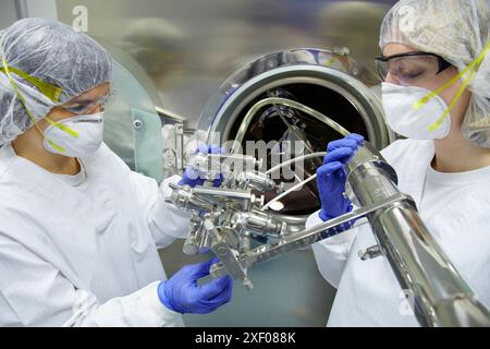 Technicians performing maintenance functions on a solid coating machine, Clean room, Pharmaceutical plant, Drug manufacturing plant, Research Center, Stock Photo