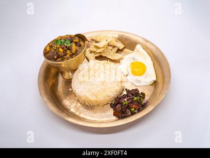 Nepali Thali Set with Kwati Mix Bean Soup, Rice, Omlette in a plate for Janai Purnima or Gunhi Punhi Stock Photo