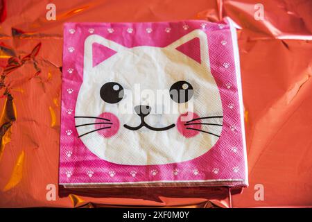 Close-up of paper napkins on colorful table decorated with cat design for child's birthday party. Stock Photo