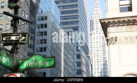 Fifth avenue, 5 ave road sign, Manhattan midtown highrise skyscraper architecture, New York City 5th av, 42 street corner near Bryant Park, Library. Traffic crossroad signage, USA. Chrysler Building. Stock Photo