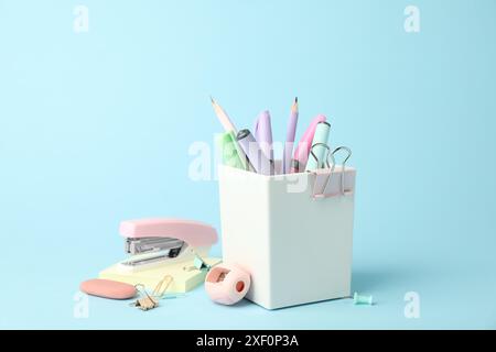 Stapler and other stationery on light blue background Stock Photo