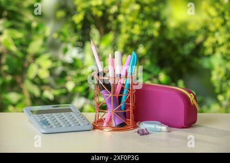 Holder, pencil case, calculator and other different stationery on white table Stock Photo