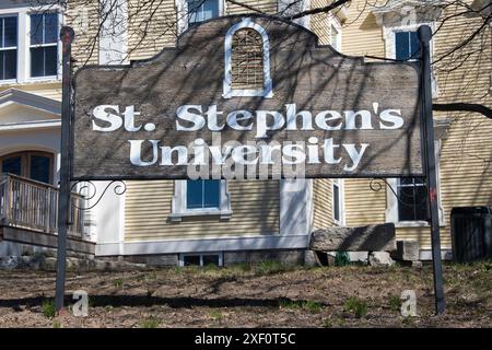 St. Stephen's University sign on Main Street in St. Stephen, New Brunswick, Canada Stock Photo