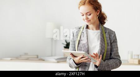 Woman Using Tablet in Fashion Studio Stock Photo