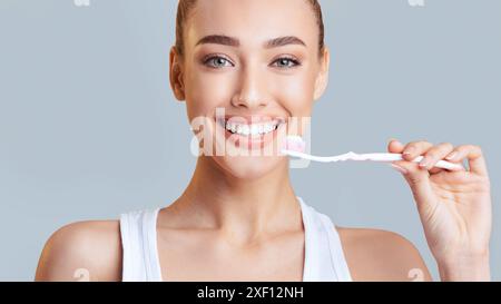 Woman Brushing Teeth With Toothbrush and Toothpaste Stock Photo