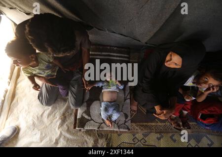 Noura Abu Al-Saud, a displaced Palestinian, lives in a tent inside a ...