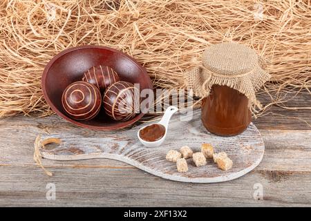 Homemade rosehip marmalade in glass bowl with fresh rose hip fruits on rustic background ( rosa canina ). Organic delicious rosehip, Rose hip marmalad Stock Photo