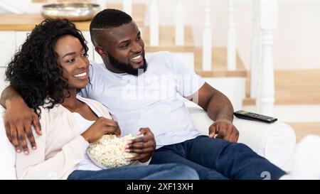 Couple Relaxing On Couch With Popcorn Stock Photo