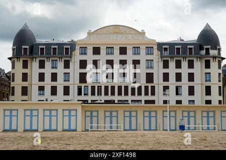 A row of beach huts in front of the Trouville Palace a former hotel, on the seafront Trouville-sur-Mer, Normandy, France Stock Photo