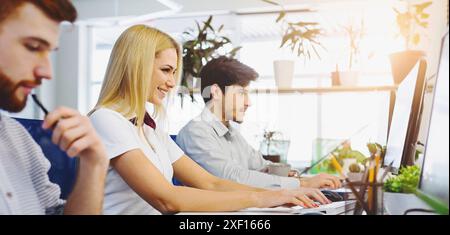 Diverse young people using office computers at coworking Stock Photo