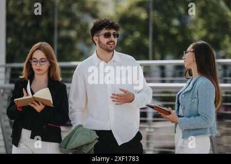 Business professionals engaged in outdoor meeting with notebooks Stock Photo