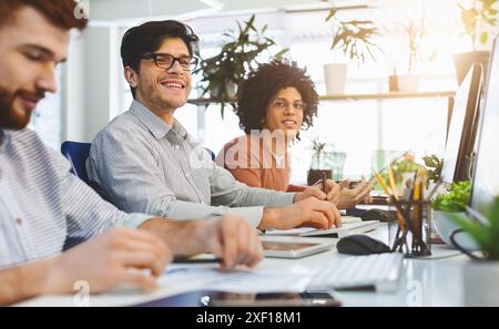 Young male team working at IT developing company Stock Photo
