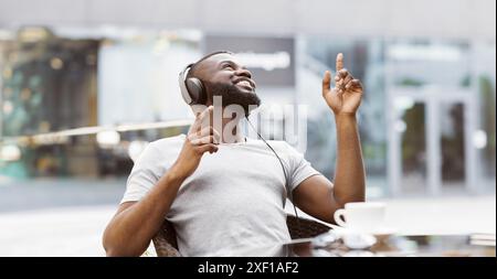 Man Dancing to Music With Headphones On Stock Photo