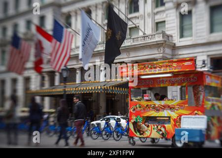 A typical Gyros food truck parked in front of the elegant Plaza hotel with flags of United States and Canada, Manhattan, New York City. The image has Stock Photo