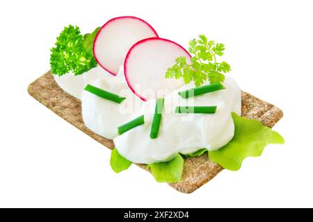 Crispbread and curd with fresh herbs isolated on white background Stock Photo
