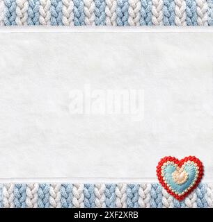 Vertical backdrop with suede texture, wool border with pigtailed ornament and felt heart. Christmas background with suede leather and plaited frame of Stock Photo
