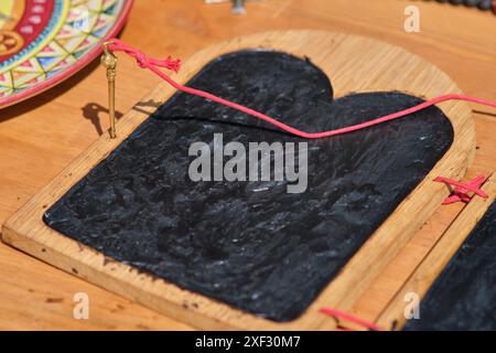 Creation of wooden religious icons in the Middle Ages. On a wooden surface, there is a black slate Stock Photo