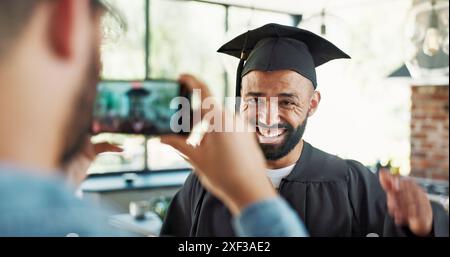 Graduation, student and excited with photo in home for certificate, diploma and success in education. Man, picture and memory for social media post Stock Photo
