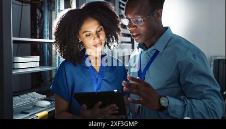 Server room, people and digital tablet for inspection, maintenance and system update. Software management, programmer and teamwork for problem solving Stock Photo