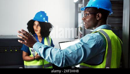 Team, engineer and hardware maintenance in server room for system inspection, update or network on computer. Data center, people or technician Stock Photo