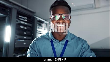 Man, happy and smiling or working in server room, system update and firmware installation or program developer. Online, network and cybersecurity or Stock Photo