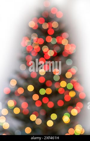 Christmas tree illuminated with garlands of lights, defocused image, bokeh Stock Photo
