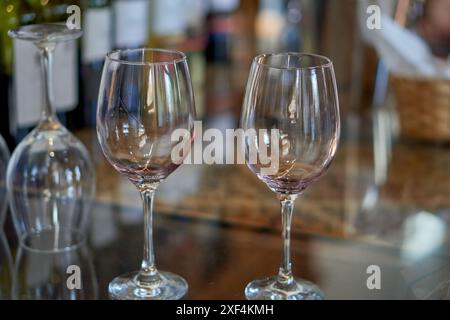 2 empty wine glasses on a table at a wine tasting in Cafayate, Argentina. Out of focus background Stock Photo