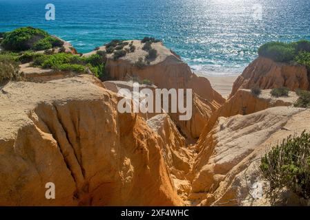 beautiful beach in the Atlantic Ocean view from  yellow hard sand cliffs forming a canyon Medides beach in Portugal Stock Photo