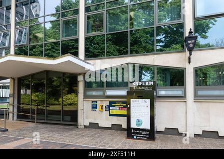 Knife bin outside Essex police station at Southend on Sea, Essex, UK. Metal bin for the deposit and disposal of knifes and blades. Schoolboy artwork Stock Photo