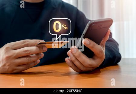Shopping online with special offer installment payments. Zero percent rate in speech bubble appear when businessman using mobile smart phone and pay b Stock Photo