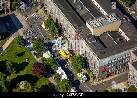 Aerial view, Himmelfahrtskirmes on the Ruhrstraße at the building of the Sparkasse Witten headquarters, carousel and stalls, Witten, Ruhr area, North Stock Photo