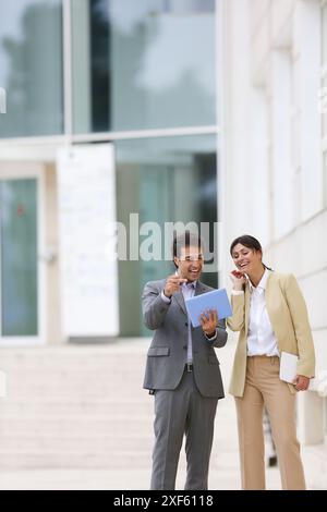 Businessman and business woman with tablet in business center. San Sebastian Technology Park. Donostia. Gipuzkoa. Basque Country. Spain. Stock Photo