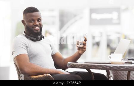 Man Using Smartphone at Cafe Stock Photo