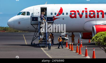 Passengers disembarking on holiday from Avianca Airlines aeroplane, San Cristobal airport, Galapagos Islands, Ecuador Stock Photo