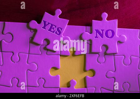 A puzzle with a piece missing and the words "yes" and "no" written on the options Stock Photo