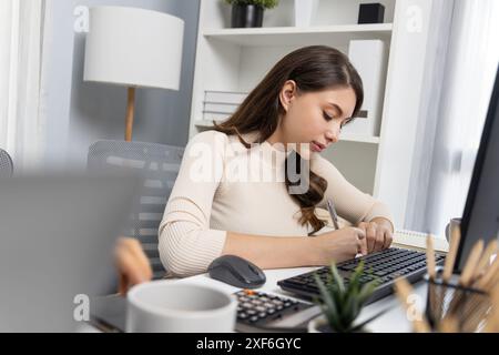 Casual outfit beautiful businesswoman searching research report on pc and writing note script to create marketing plan to analyze customer target with Stock Photo