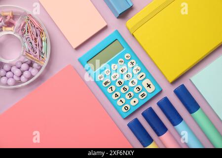Flat lay composition with notebooks and different stationery on violet background Stock Photo