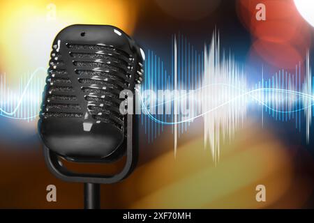 Microphone and audio waveform on blurred background Stock Photo