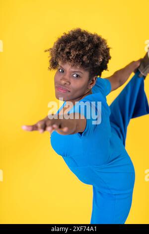 Woman in Blue Jumpsuit Pointing at Camera Stock Photo