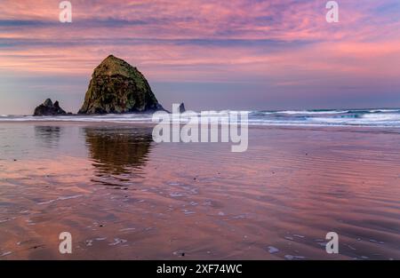 Haystack Rock at sunrise in Cannon Beach, Oregon, USA. Stock Photo