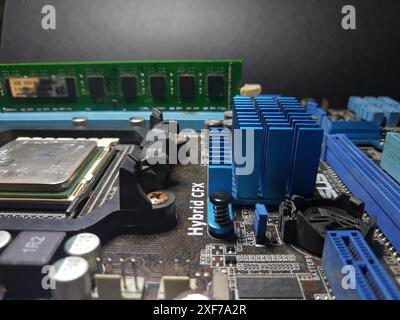 A close-up of a microchip with many electrical components placed on the motherboard. Computer Hardware. Stock Photo