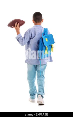 Little schoolboy with blue backpack and rugby ball on orange background ...