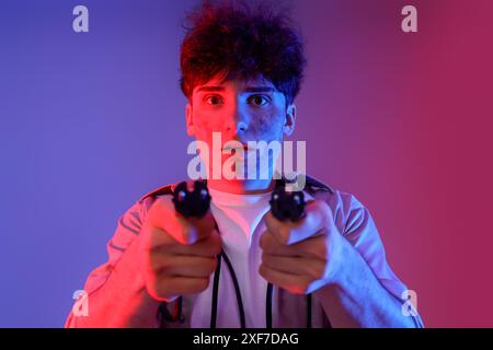 Electrocuted young man with burnt face and plugs on dark background, closeup Stock Photo