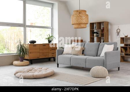 Interior of living room with sofa and glucophone on drawers Stock Photo