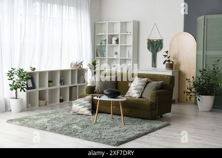 Interior of living room with green sofa and glucophone on table Stock Photo