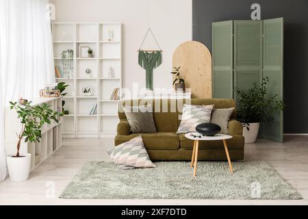 Interior of living room with green sofa and glucophone on table Stock Photo